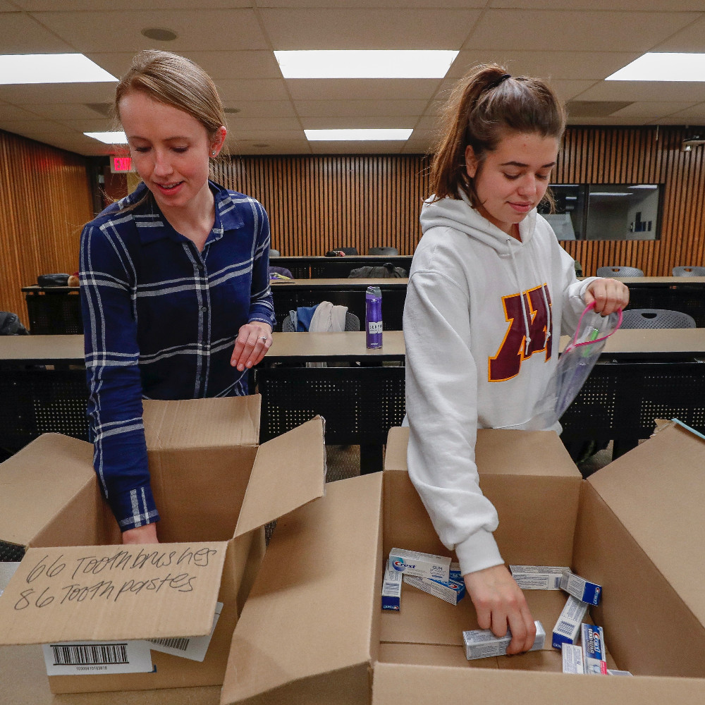 Students volunteer by filling boxes with dental needs